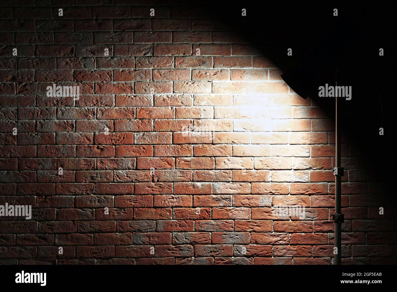 Studio light flash on brick wall background Stock Photo Alamy
