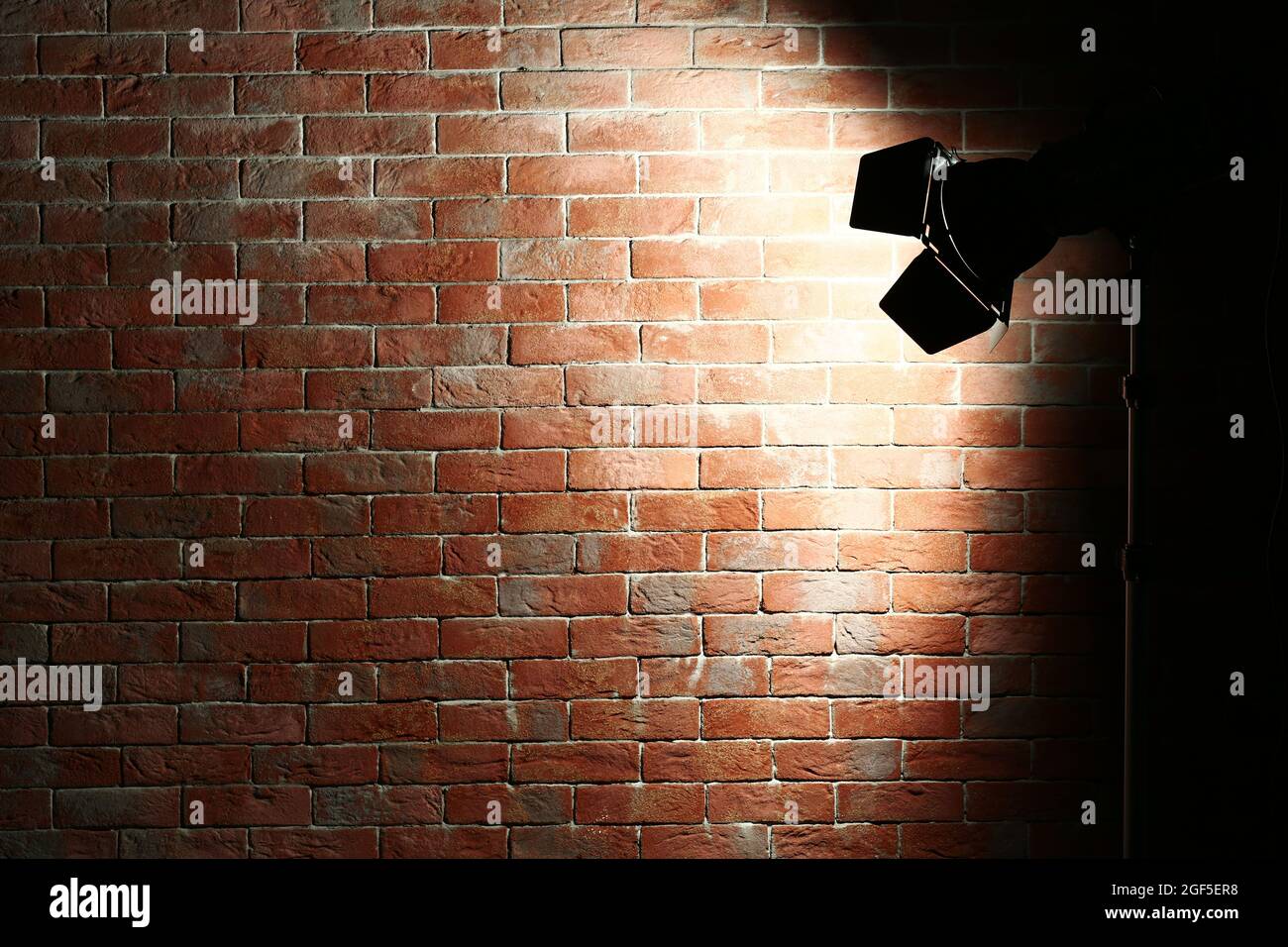 Studio light flash on brick wall background Stock Photo Alamy