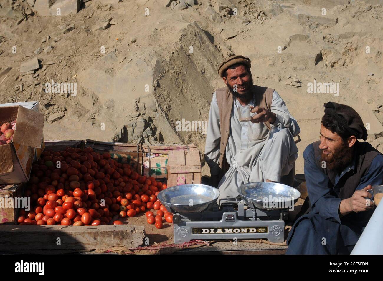 A street vendor owner poses for a picture during a normal business day in Naray, Afghanistan, Jan 21. Stock Photo