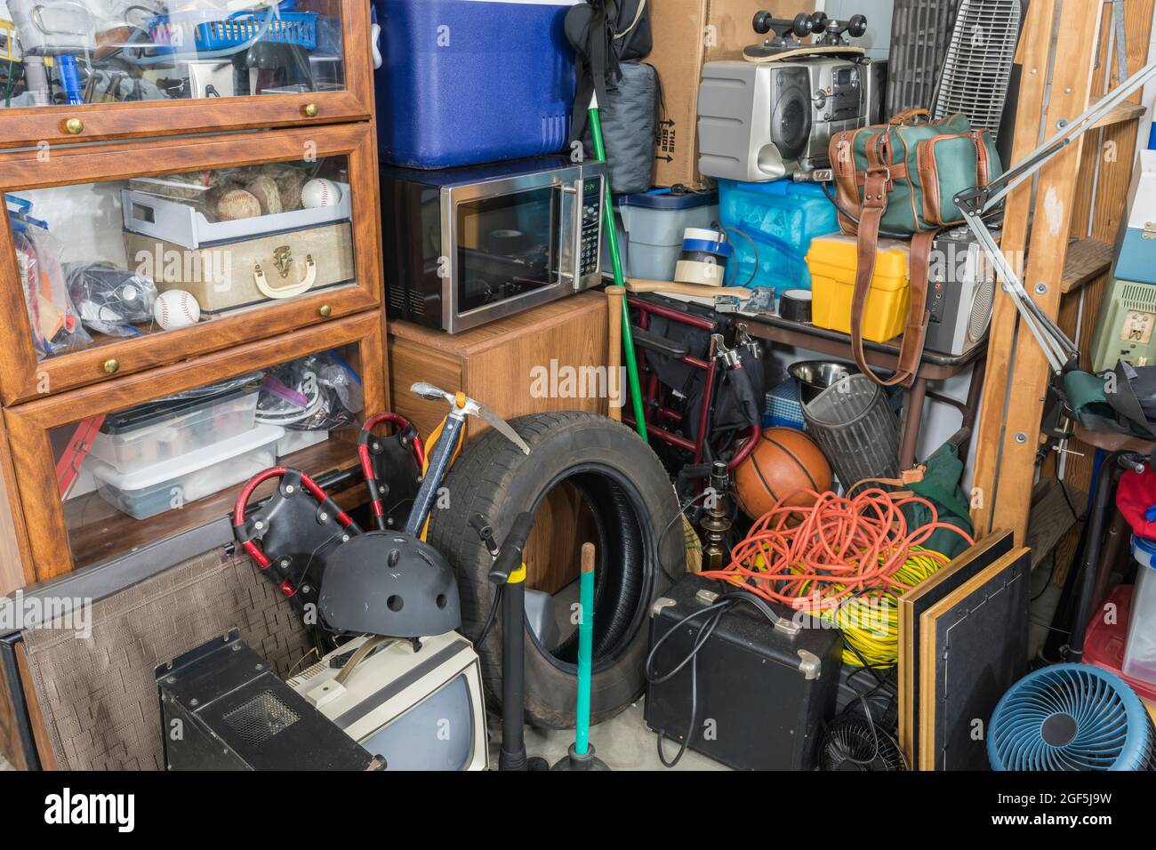 Storage clutter and household junk filling garage corner. Stock Photo