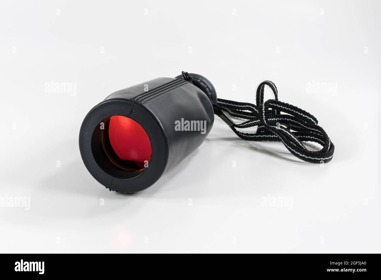 Monocular with red colored coated lens and white background. Stock Photo