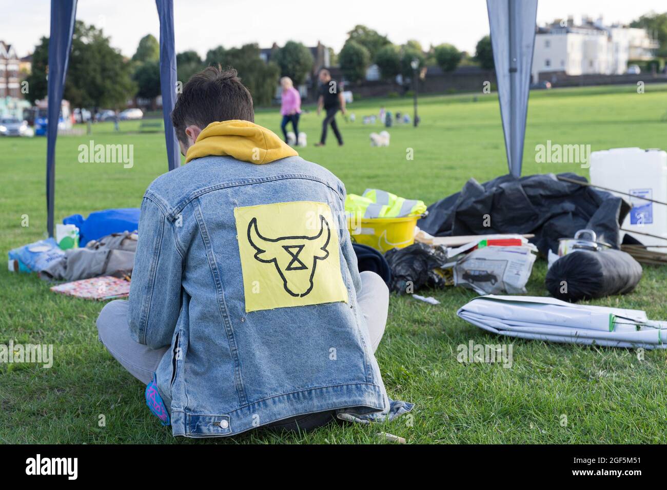 man wears a jean jacket with Animal rebellion logo on its back, South London Greenwich England Stock Photo