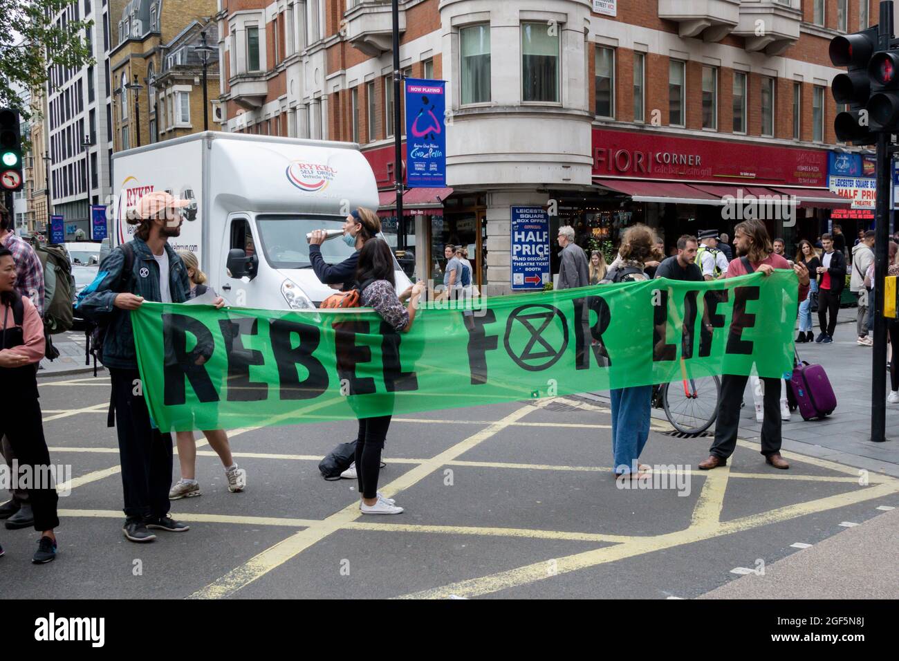 London, United Kingdom, 21st August 2021:- Extinction Rebellion protesters holding a Rebel for Life banner block traffic Stock Photo
