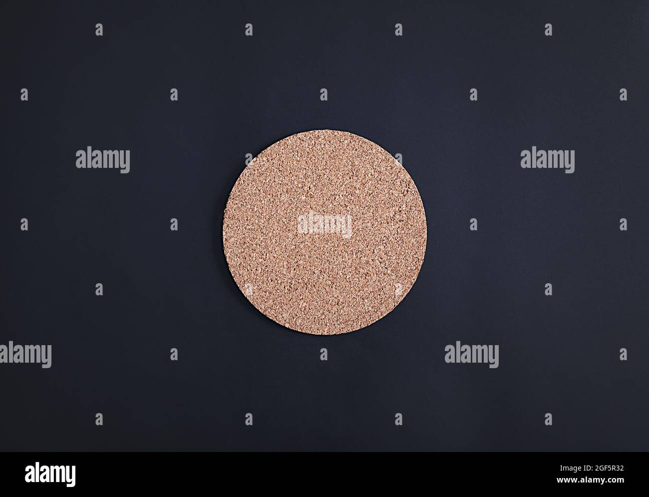 Cork drink coaster on dark blue background Stock Photo Alamy