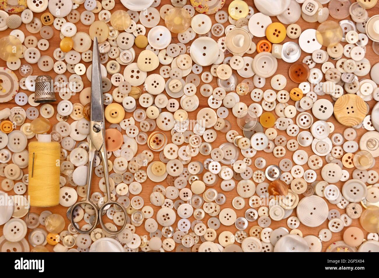 Buttons, scissors, thimble, thread and needle for sewing. Seamstress ...