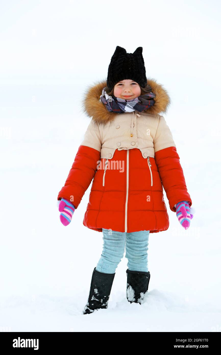 Little girl with winter clothes standing in the snow outdoor Stock Photo -  Alamy
