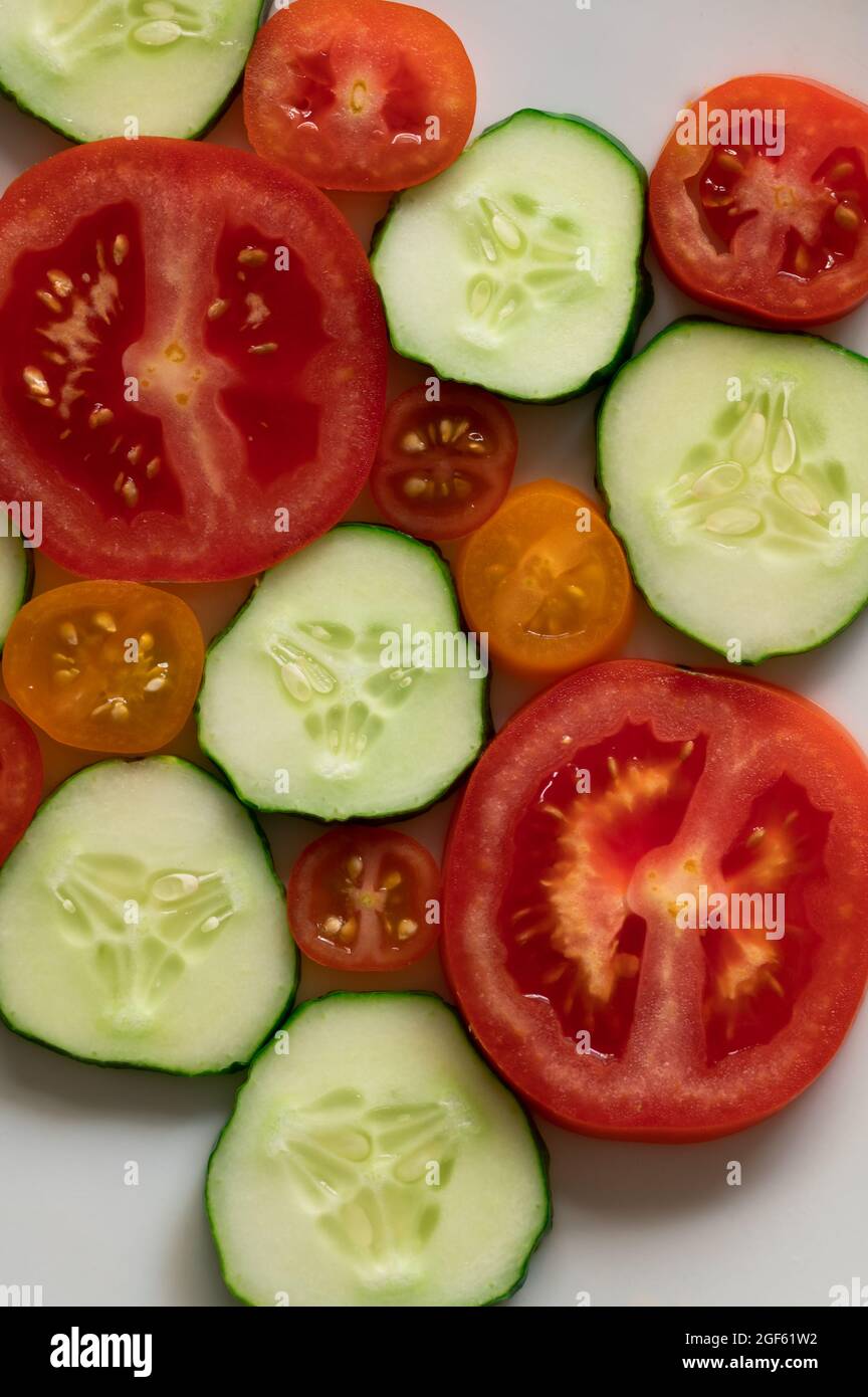 Slices of Cucumber and Tomatoes on White Background Stock Photo - Alamy