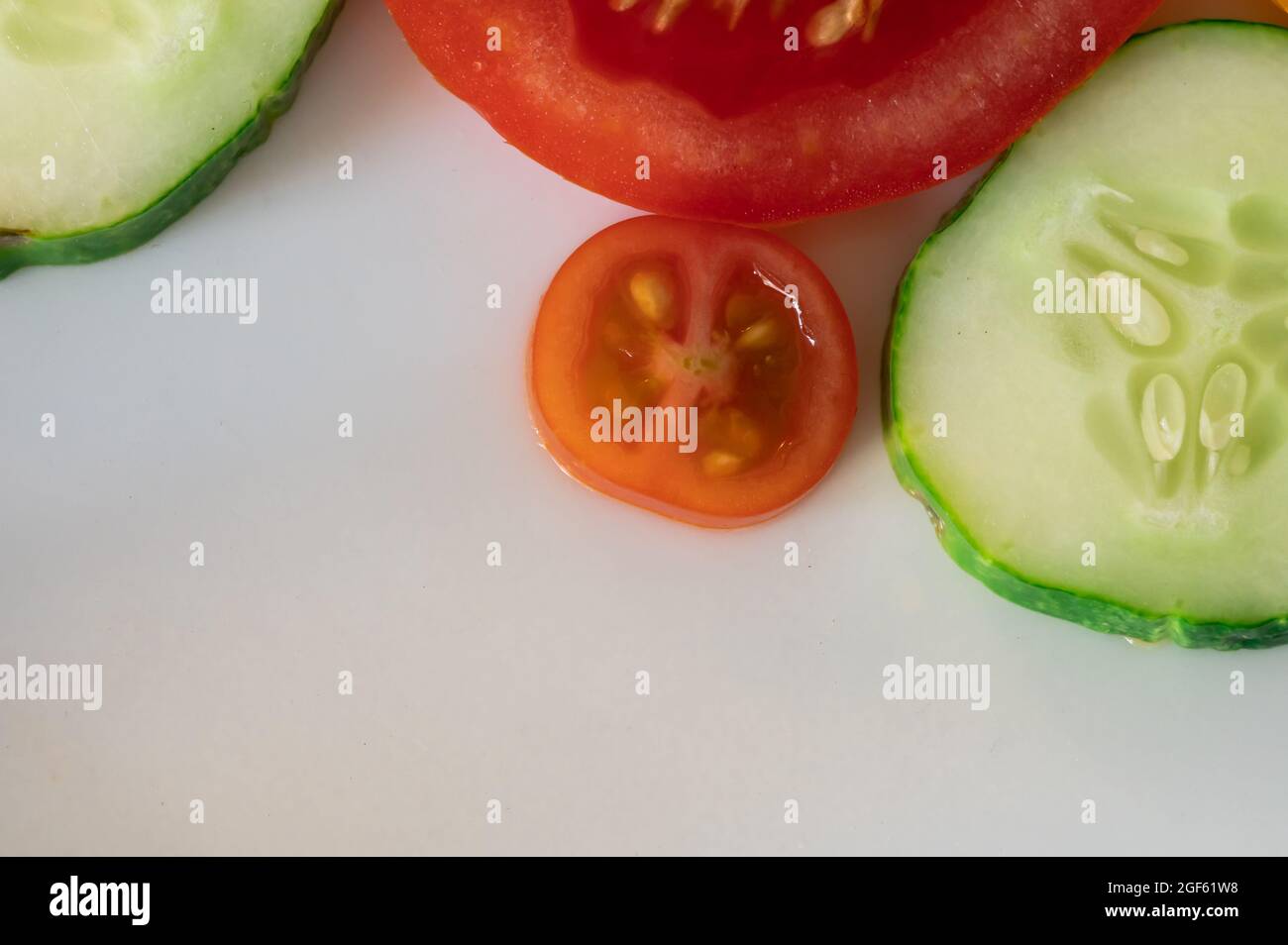 Tomato and Cucumber Slices on White Background Stock Photo - Alamy