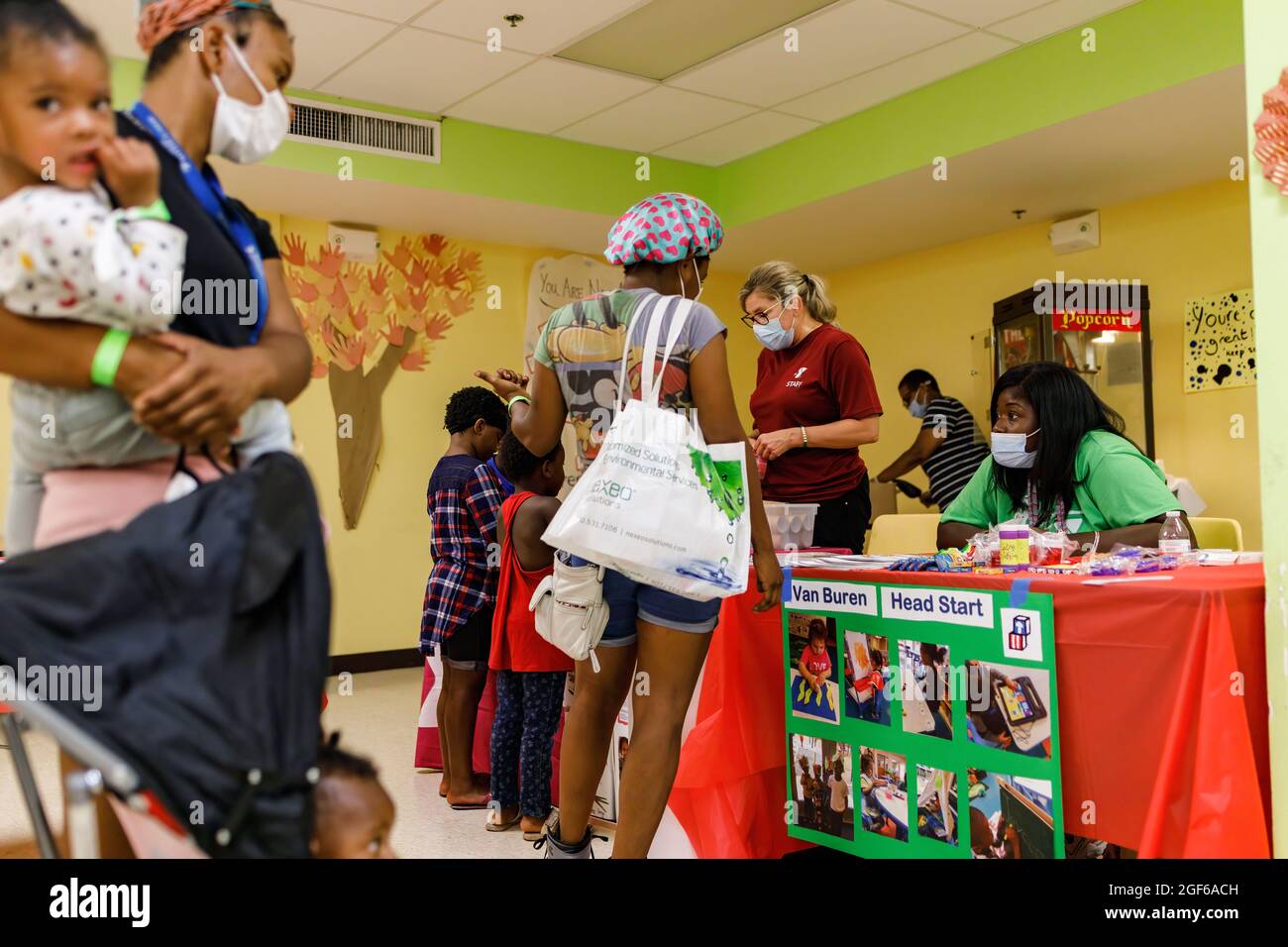 Mothers and children line up to receive support from the Van Buren