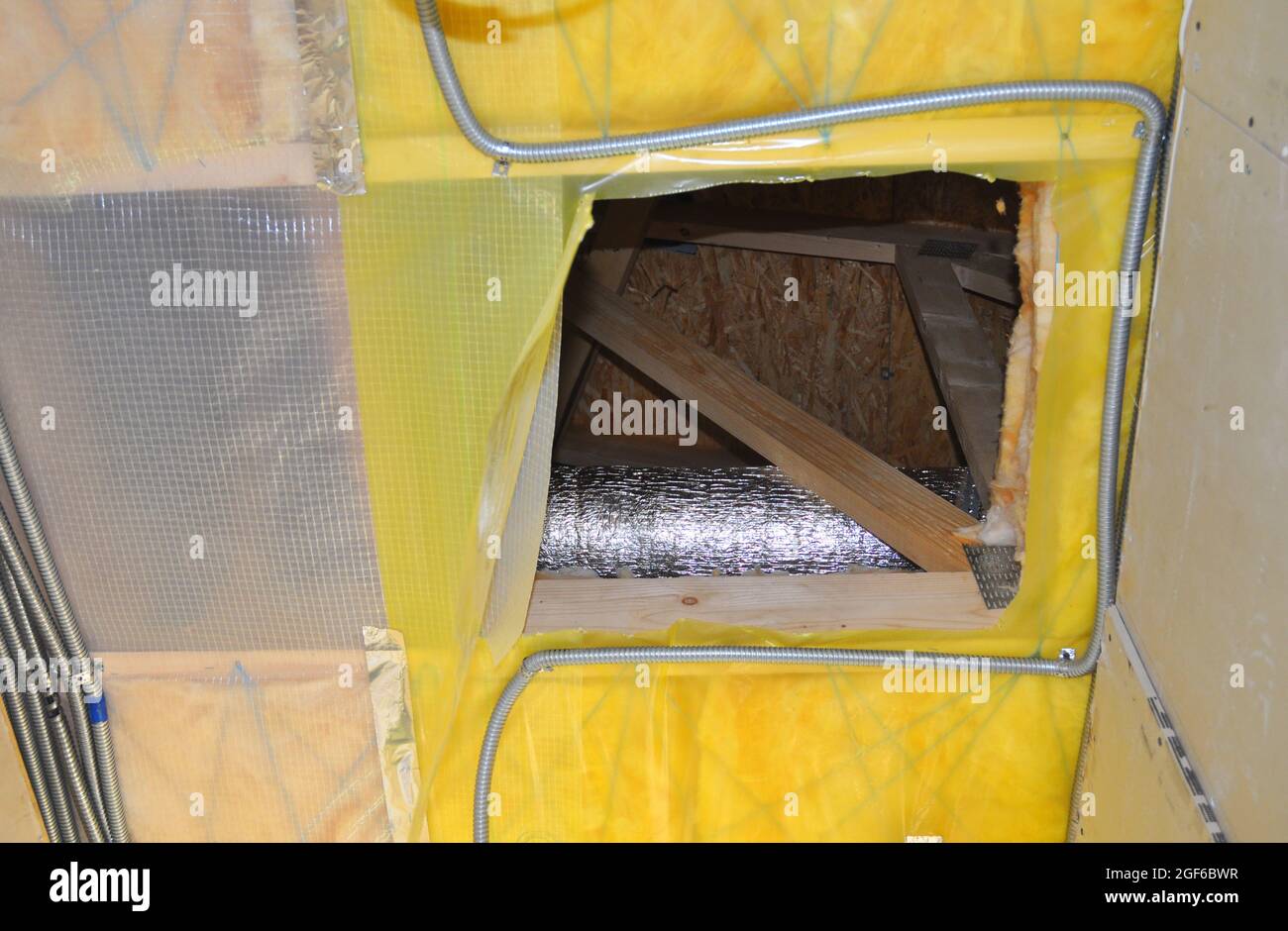 Unfinished opening for entering the loft or attic with ventilation pipe