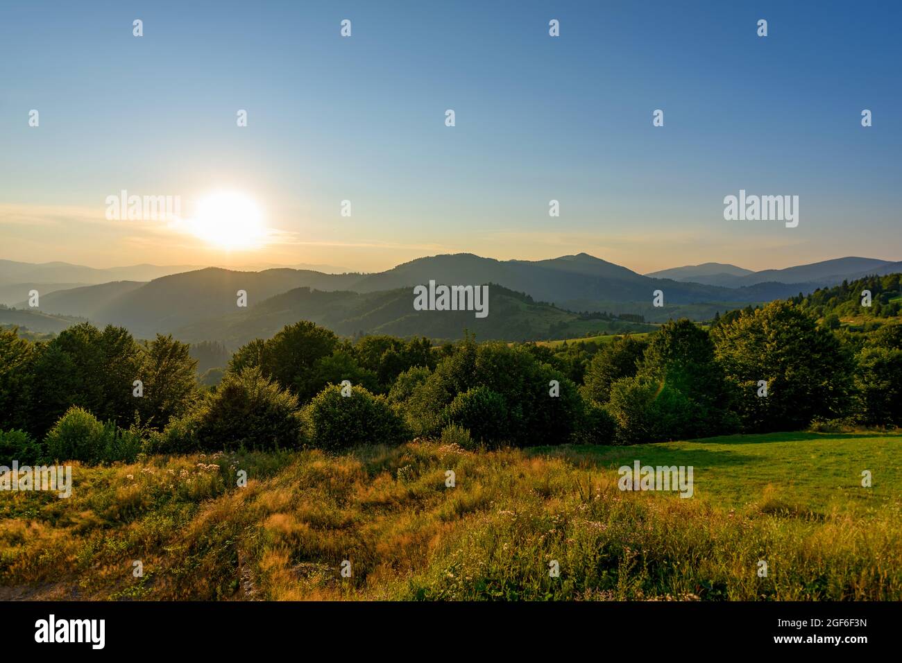 Amazing mountain landscape with colorful vivid sunset on the cloudy sky ...