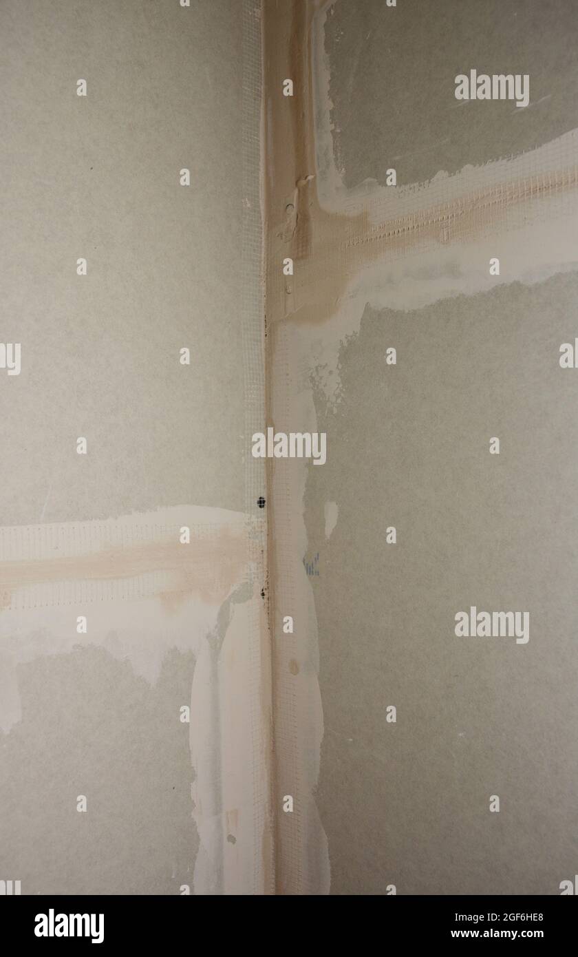 A closeup on drywall corner finishing, plastering, coating with