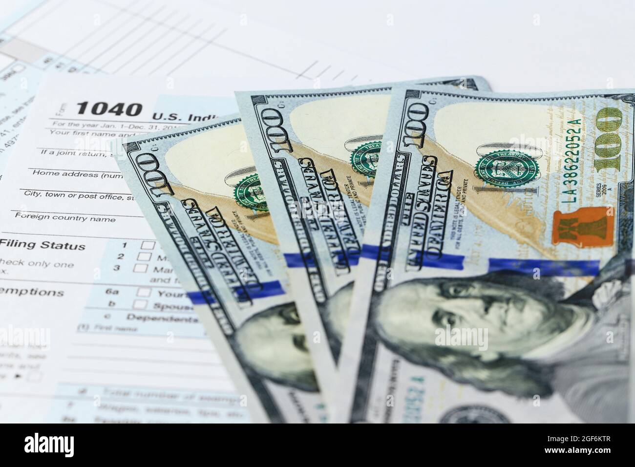 1040 Individual Tax Return Form with one hundred dollar bills, close up Stock Photo Alamy