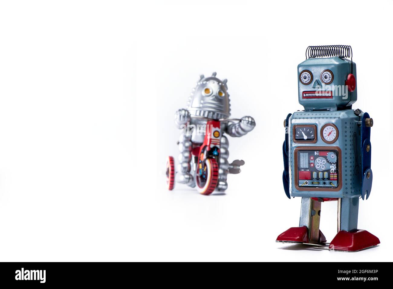 vintage tin toy robots on white background selective focus Stock Photo