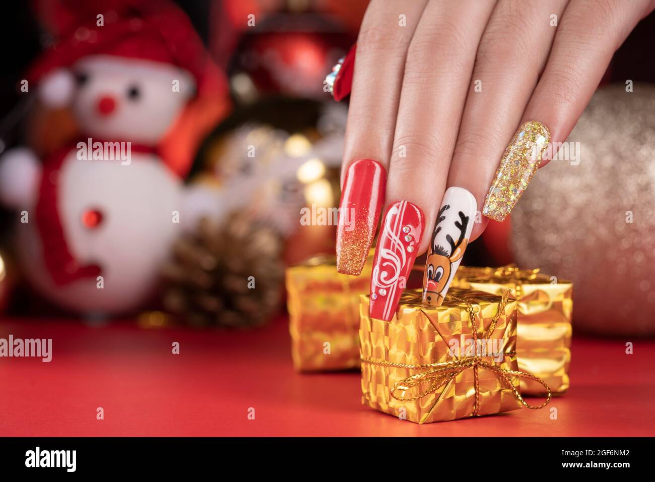 Banner with female hands with winter snow manicure with stickers under a  matte top on pink background 13675903 Stock Photo at Vecteezy