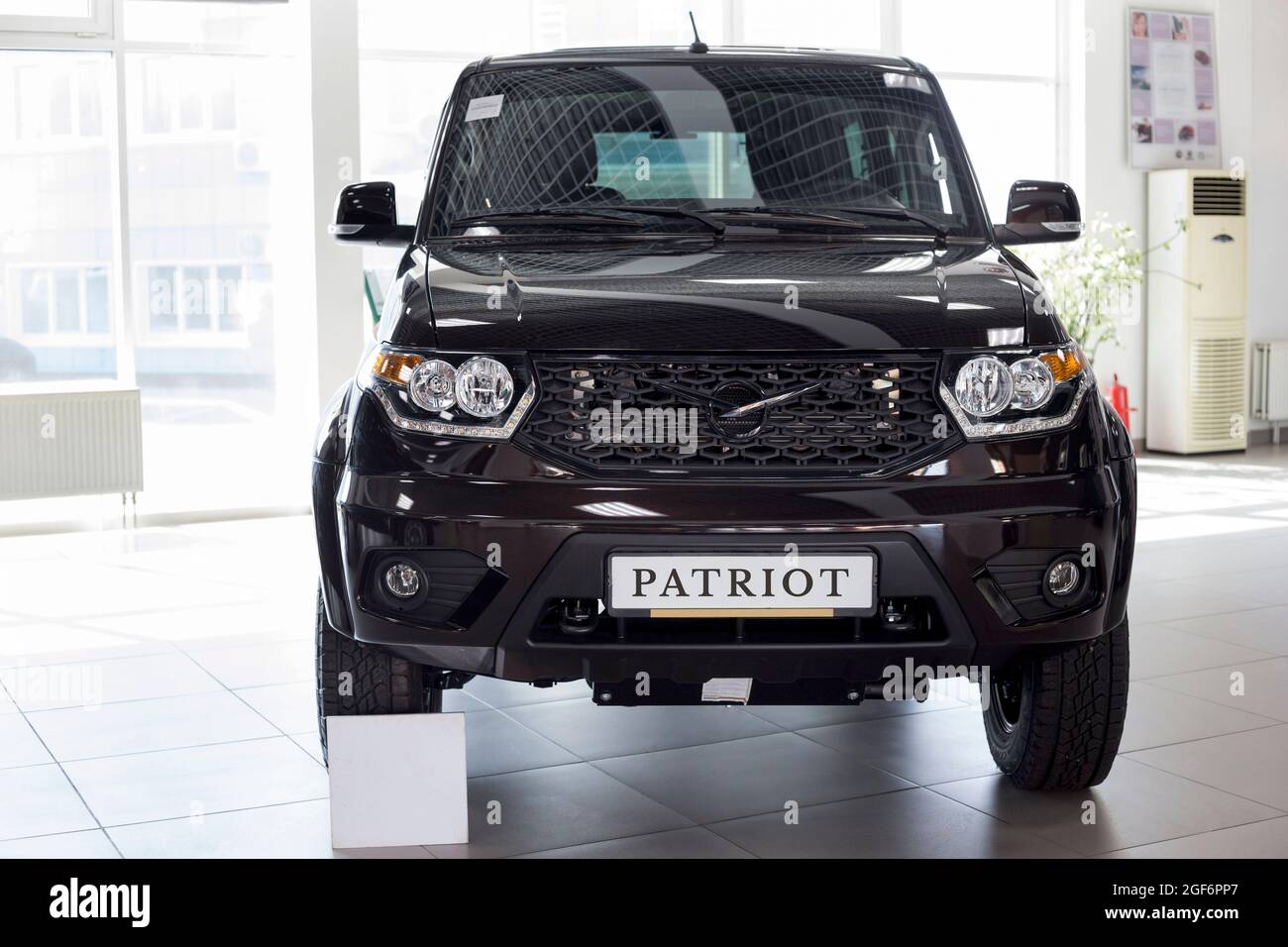 Russia, Izhevsk - August 20, 2021: UAZ showroom. New modern UAZ Patriot car in dealer showroom. Sollers automotive group. Front view. Modern transport Stock Photo