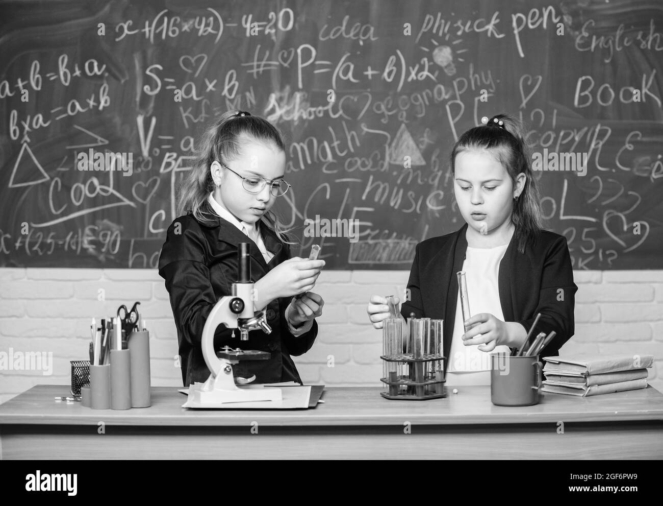 Scientific researches. Little scientist work with microscope. Little girls in school lab. Formal school education. Biology school lesson. Chemistry Stock Photo