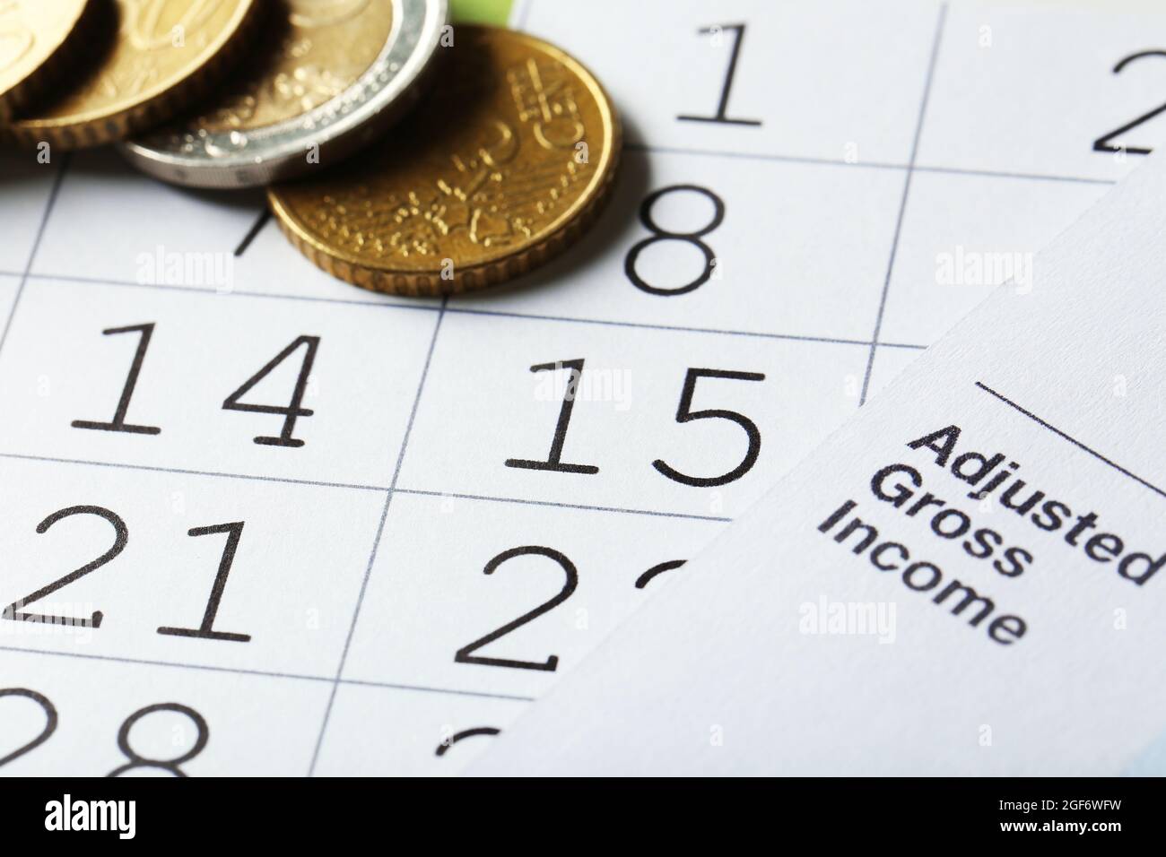 Calender with dates, euro coins and tax form, close up Stock Photo Alamy