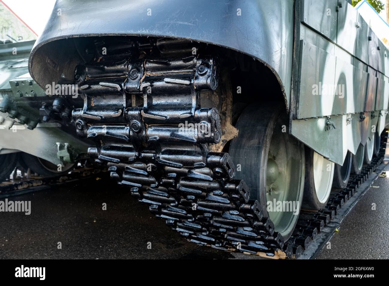 Tracked armor close-up. Black tracks and large rubberized rollers. Tank chassis Stock Photo