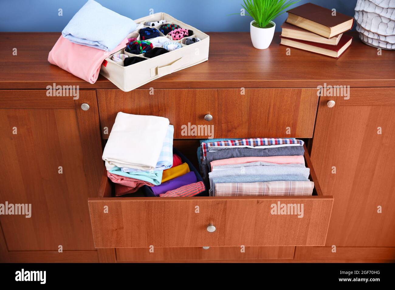 Neatly folded clothes in wooden drawer Stock Photo Alamy