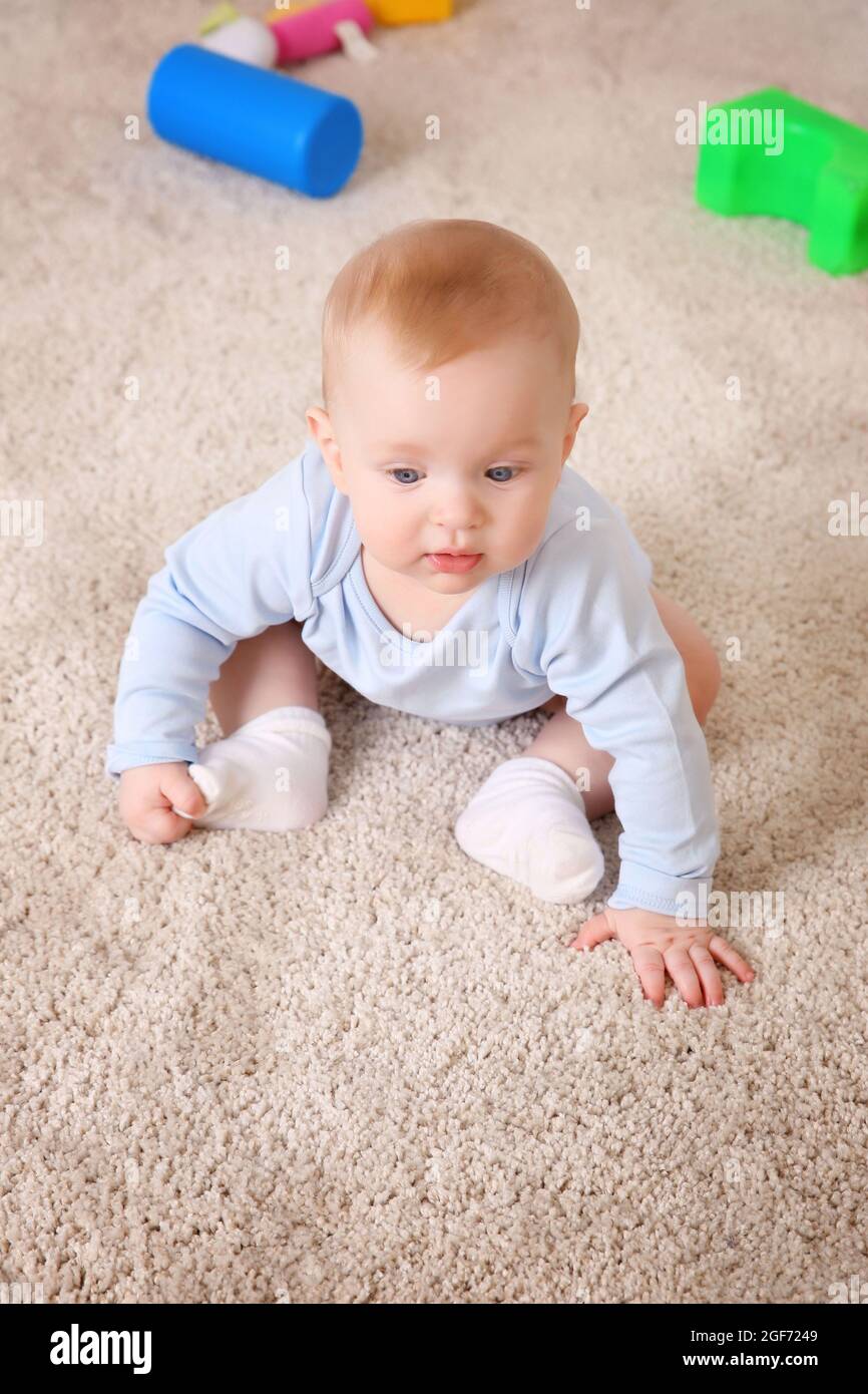Cute baby with plastic toys on the floor, close up Stock Photo Alamy
