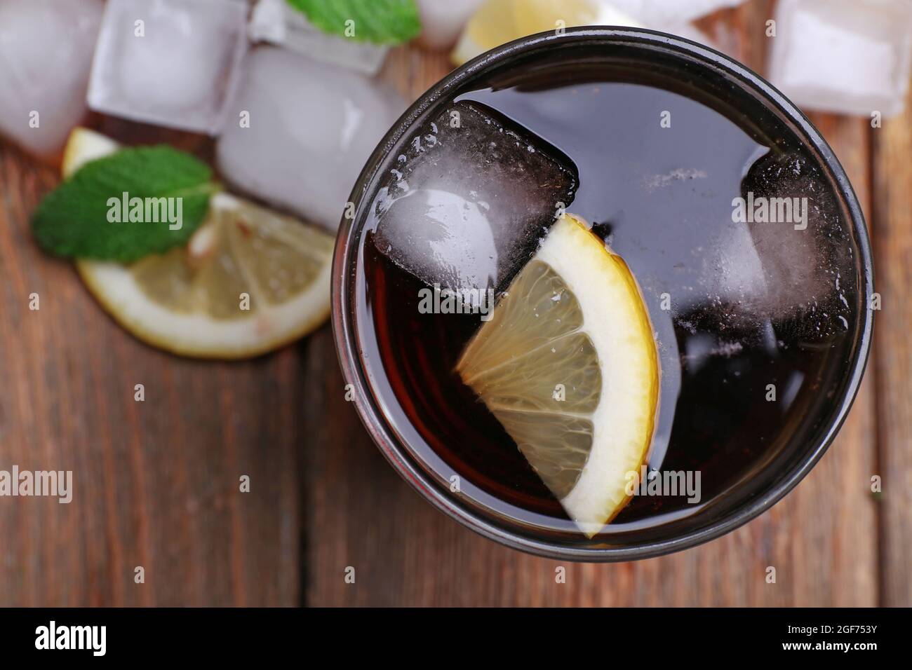 Glass of cola with cubes of ice and lemon , closeup Stock Photo - Alamy
