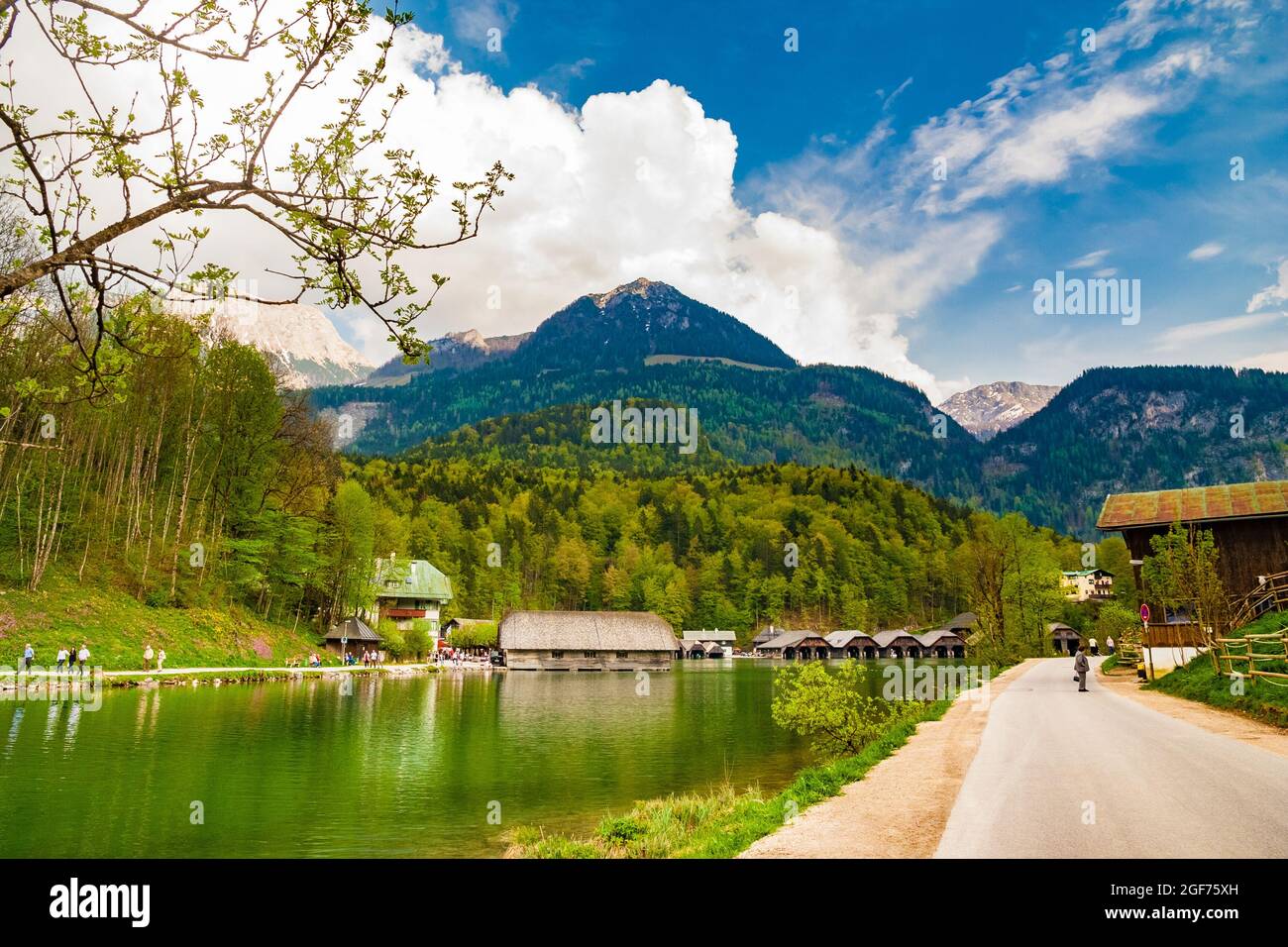 Beautiful view of the Königssee lake surrounded by mountains in Bavaria, Germany. In front is the municipality Schönau am Königssee with a row of boat... Stock Photo
