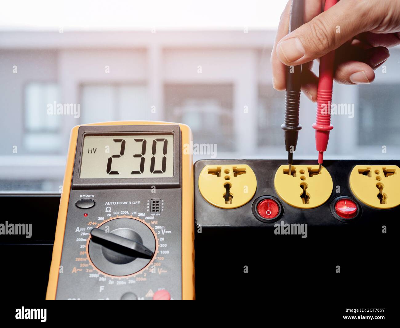 Measure the AC voltage of 230 Volts from the power outlet with a digital  meter Stock Photo - Alamy