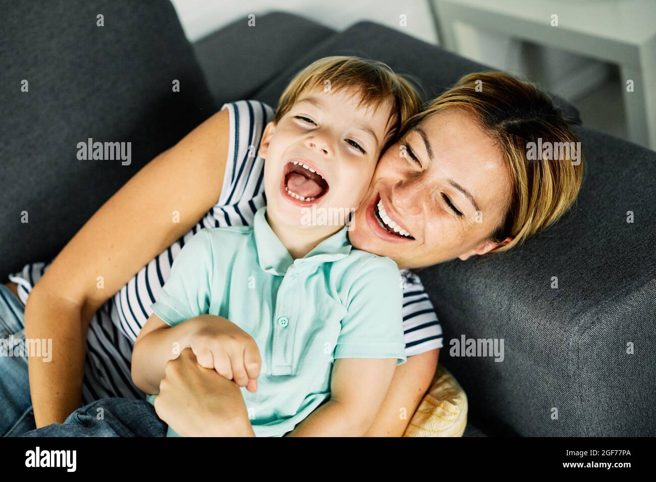 child son mother family happy playing kid childhood mom love fun smiling little woman home Stock Photo
