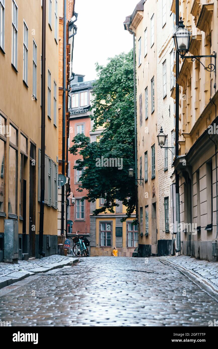 View of empty narrow cobblestoned street in Gamla Stan after rain, the Old Town is one of the largest and best preserved medieval city centers in Euro Stock Photo