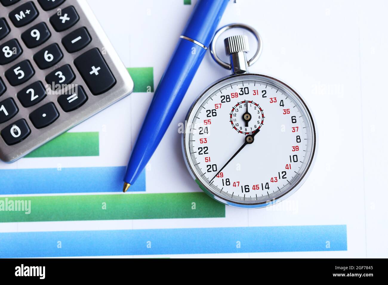 Stopwatch with calculator and pen on paper background Stock Photo - Alamy