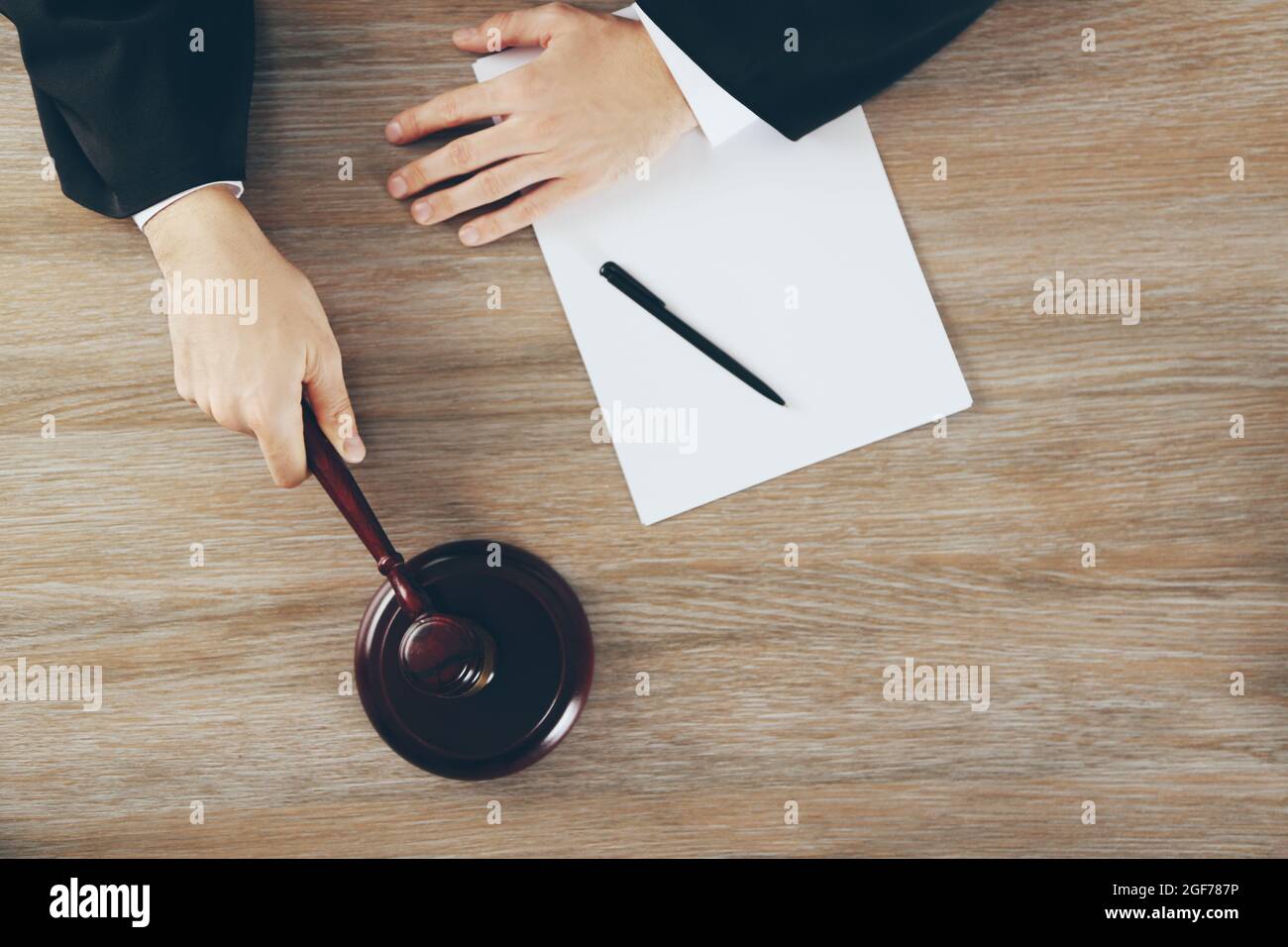 Judge hitting gavel at wooden table, top view Stock Photo Alamy