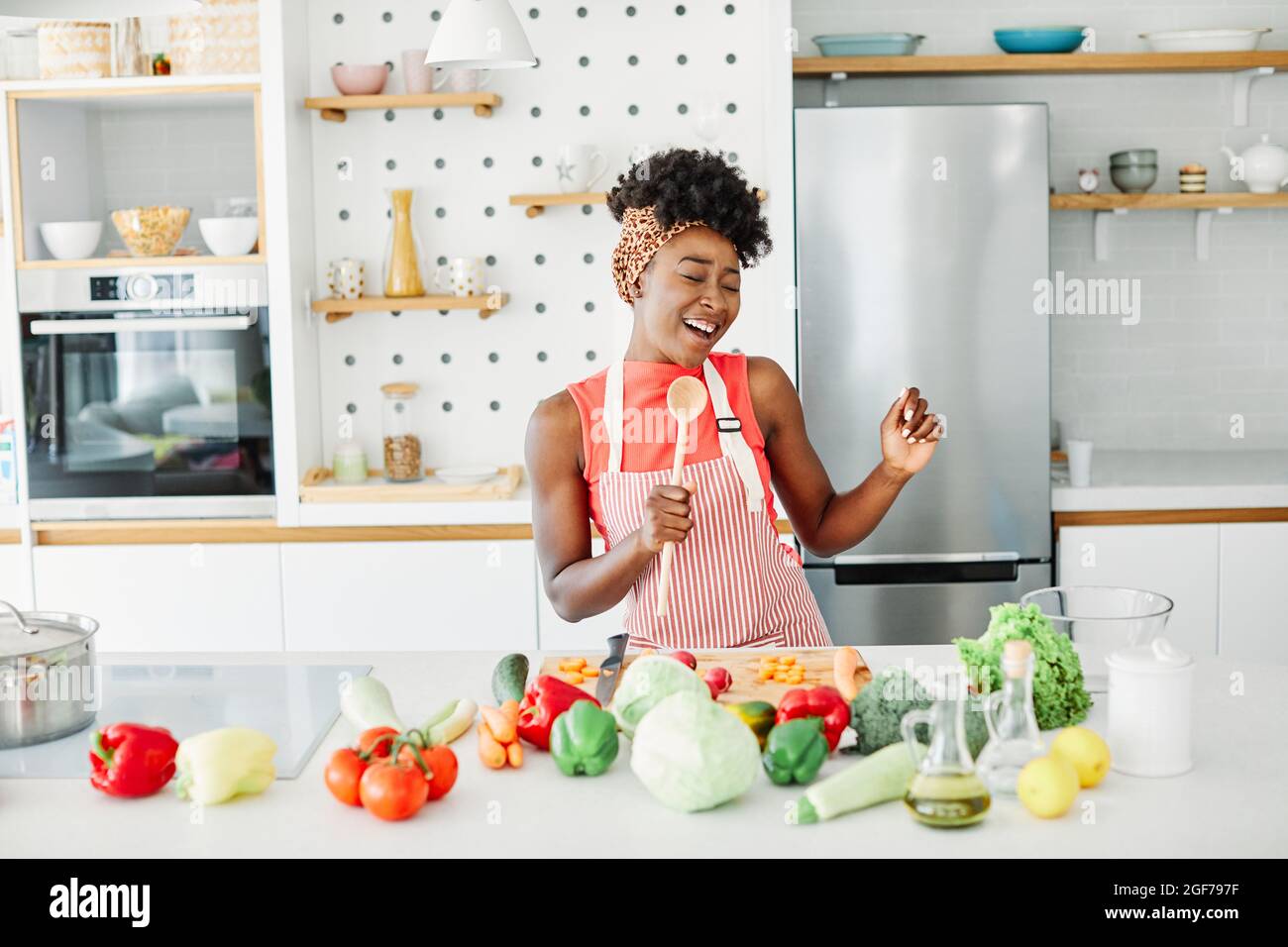 girl kitchen singing woman female happy beautiful fun young home cheerful lifestyle music Stock Photo