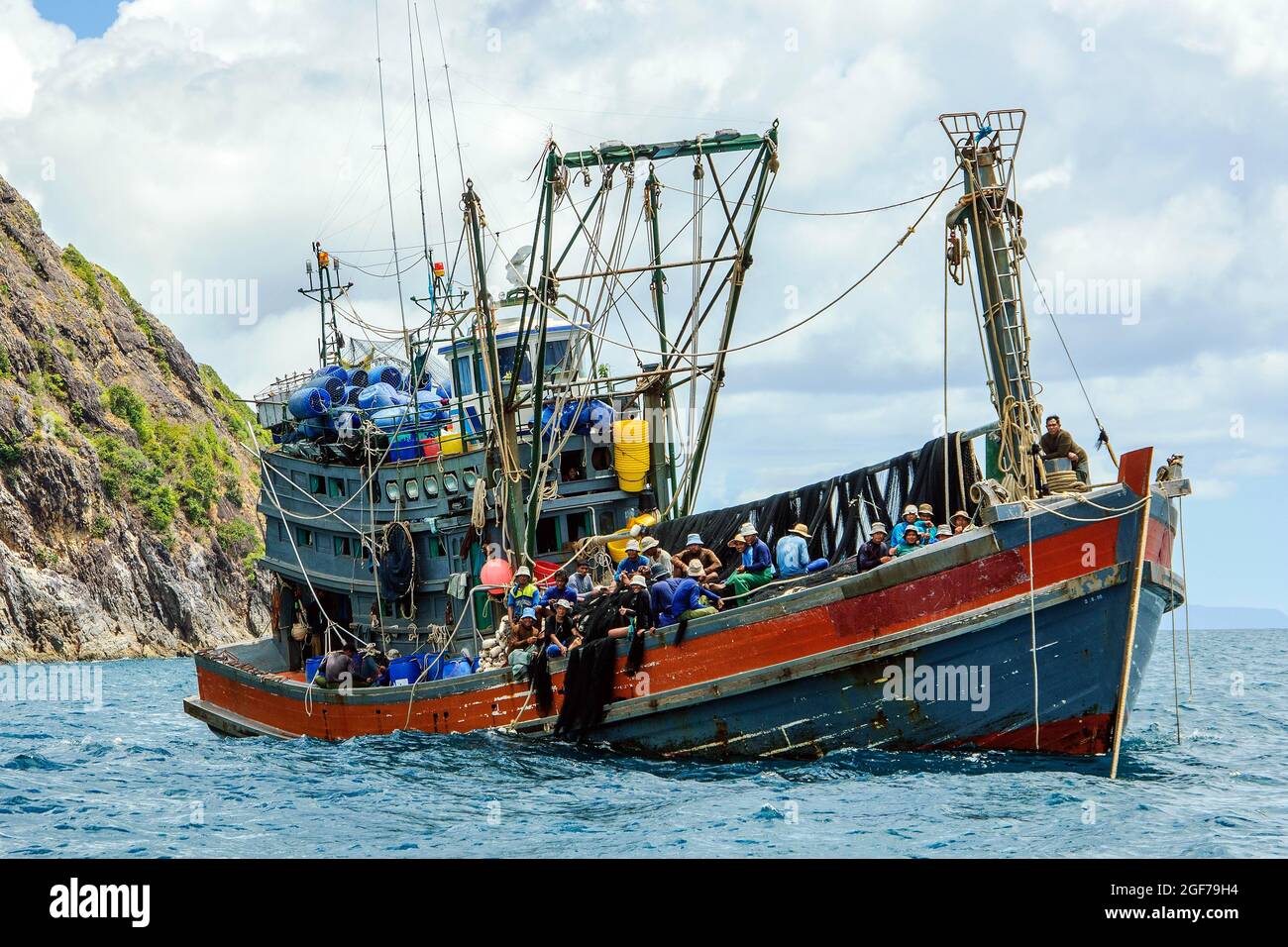 Asian fishing trawler with fisherman at railing in Andaman Sea, Myanmar