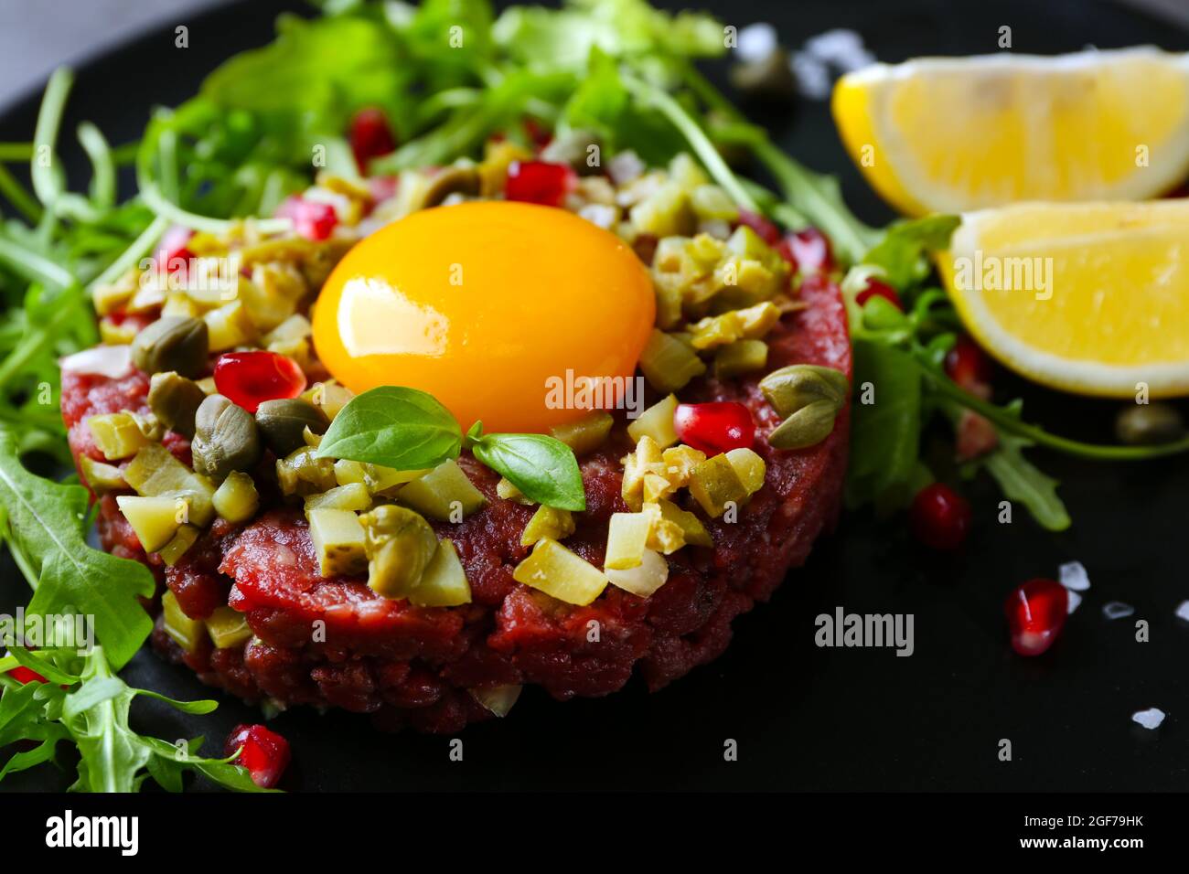 Beef tartare served in a round plate, close up Stock Photo - Alamy
