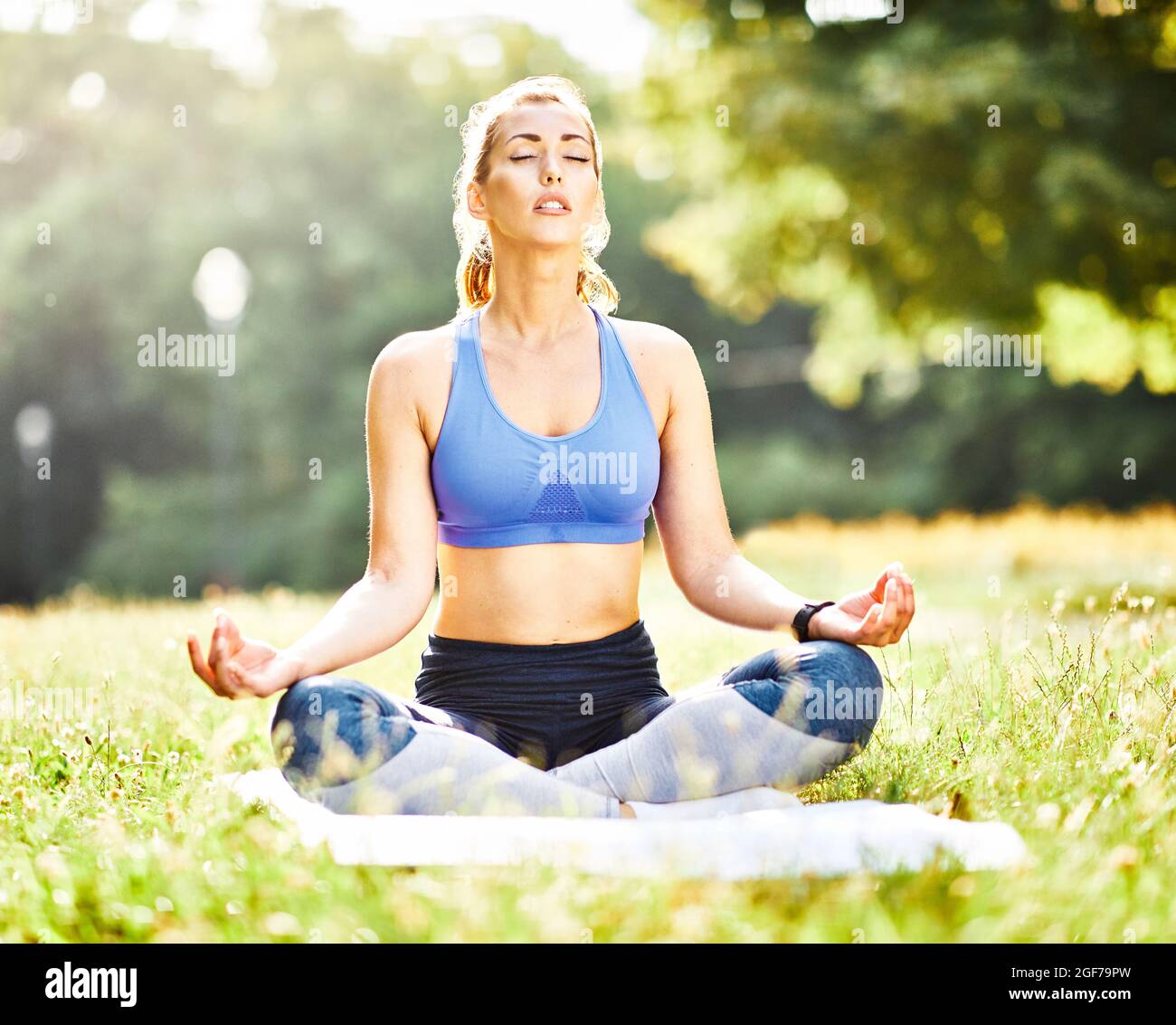 woman yoga park outdoor lifestyle nature healthy fitness sport health exercise relaxation Stock Photo