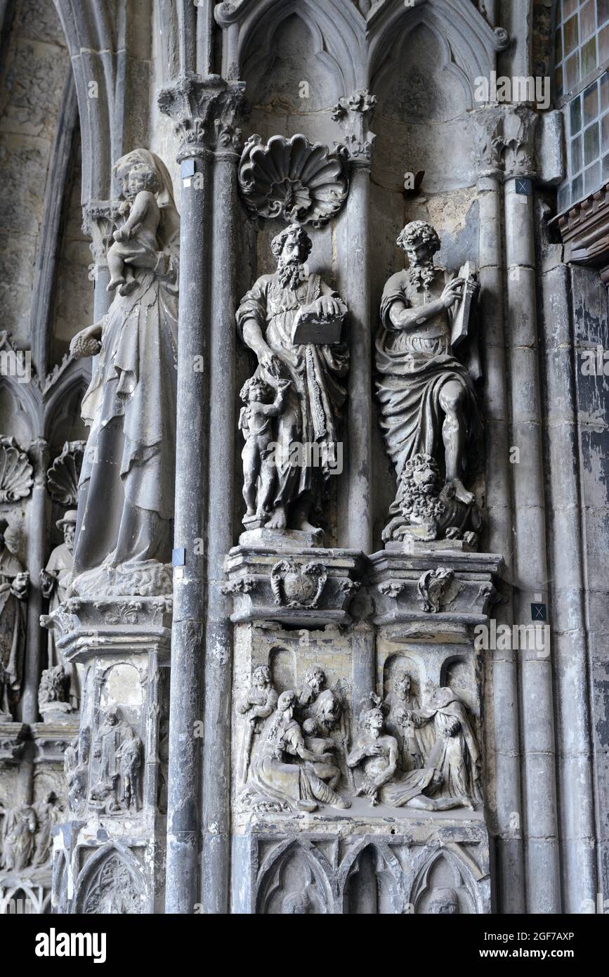 Old sculptures in need of renovation at the entrance gate to Notre-Dame Cathedral in Tournai, Hainaut Province, Wallonia, Belgium Stock Photo