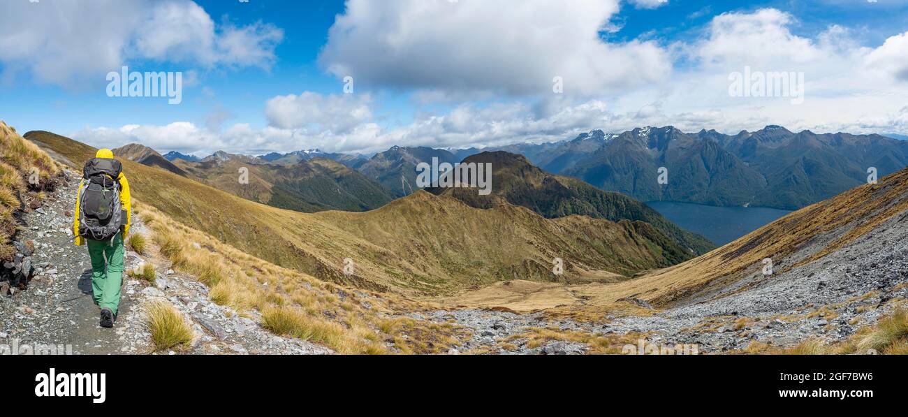 Hikers on trail, view of mountain peaks of Murchison Mountains and Kepler Mountains and Lake Te Anau, Kepler Track, Great Walk, Fiordland National Stock Photo