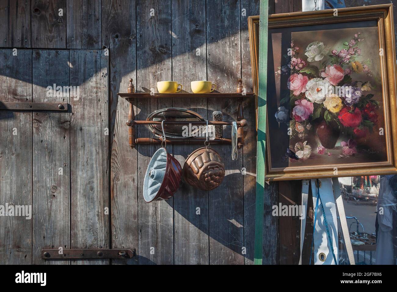 Paintings and bric-a-brac on old wooden wall, Auer Dult, Munich, Bavaria, Germany Stock Photo