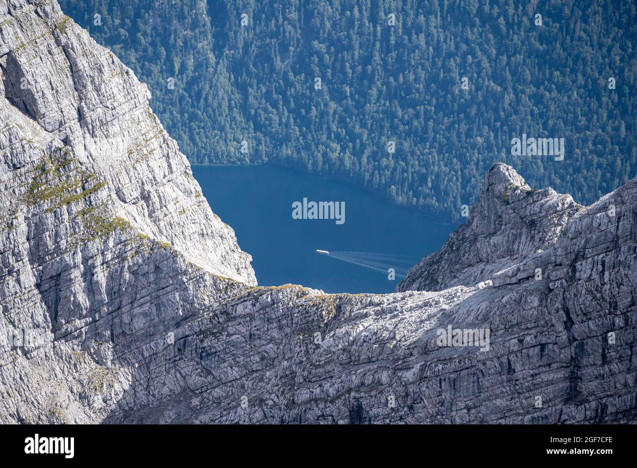 View from the Watzman Mittelspitze to Koenigsee, boat on the Koenigsee, Berchtesgaden, Bavaria, Germany Stock Photo