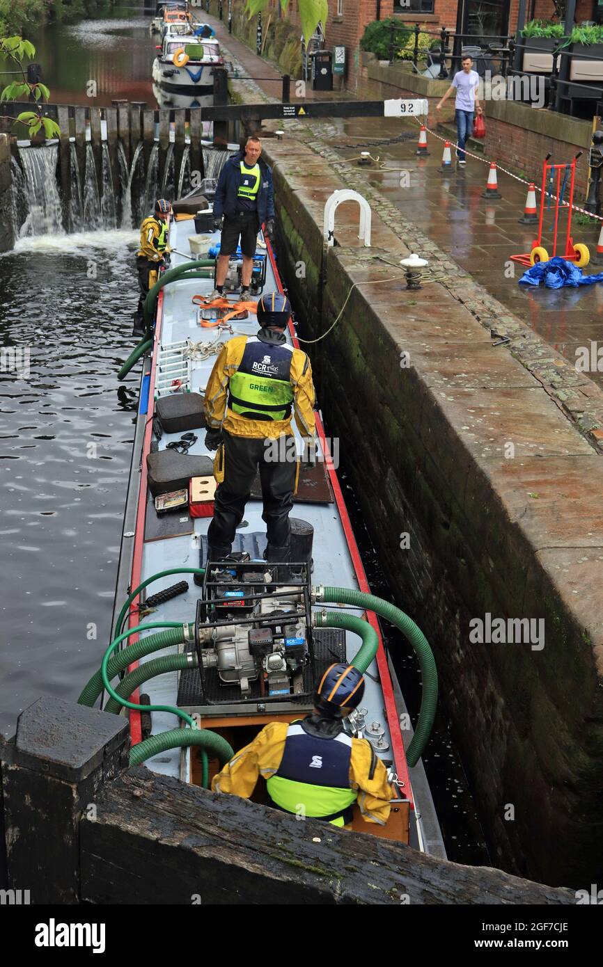 Nearly all the water has being pumped from a sunken canal boat on the Rochdale canal and its floating again. This is image 5 of the rescue operation Stock Photo