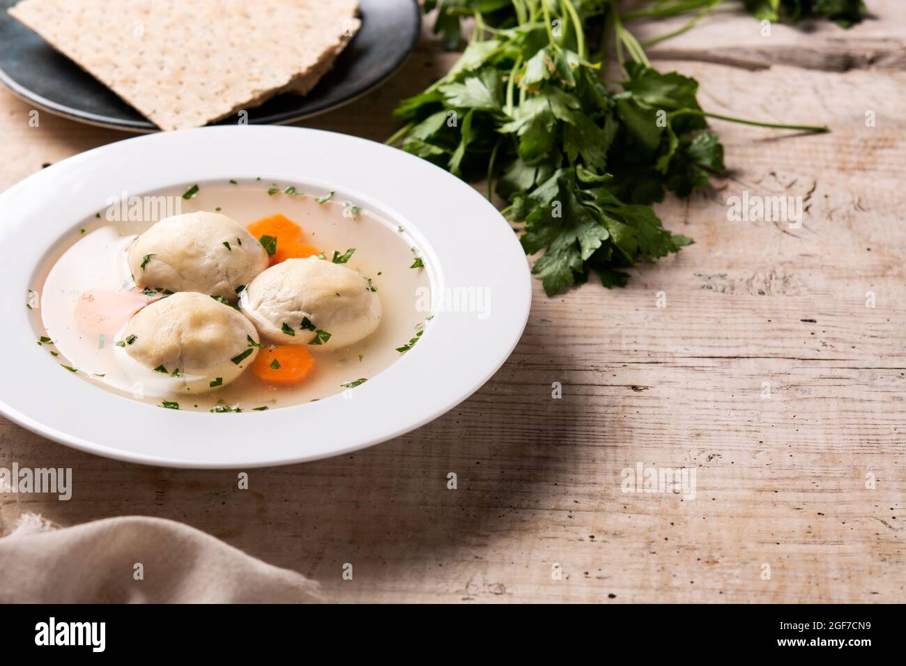 Traditional Jewish matzo ball soup on wooden table Stock Photo
