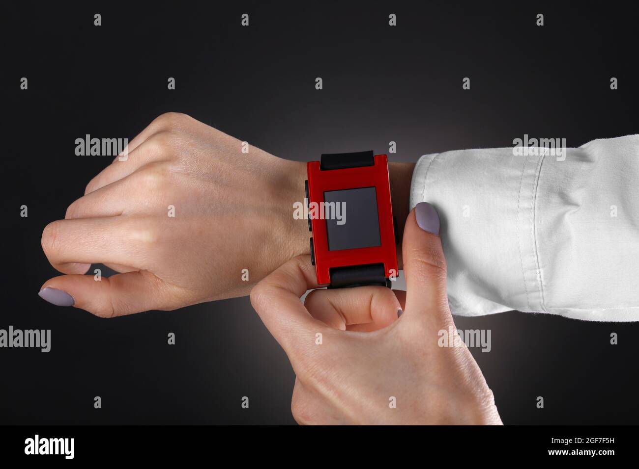 Modern watch on a woman’s wrist over black background Stock Photo - Alamy