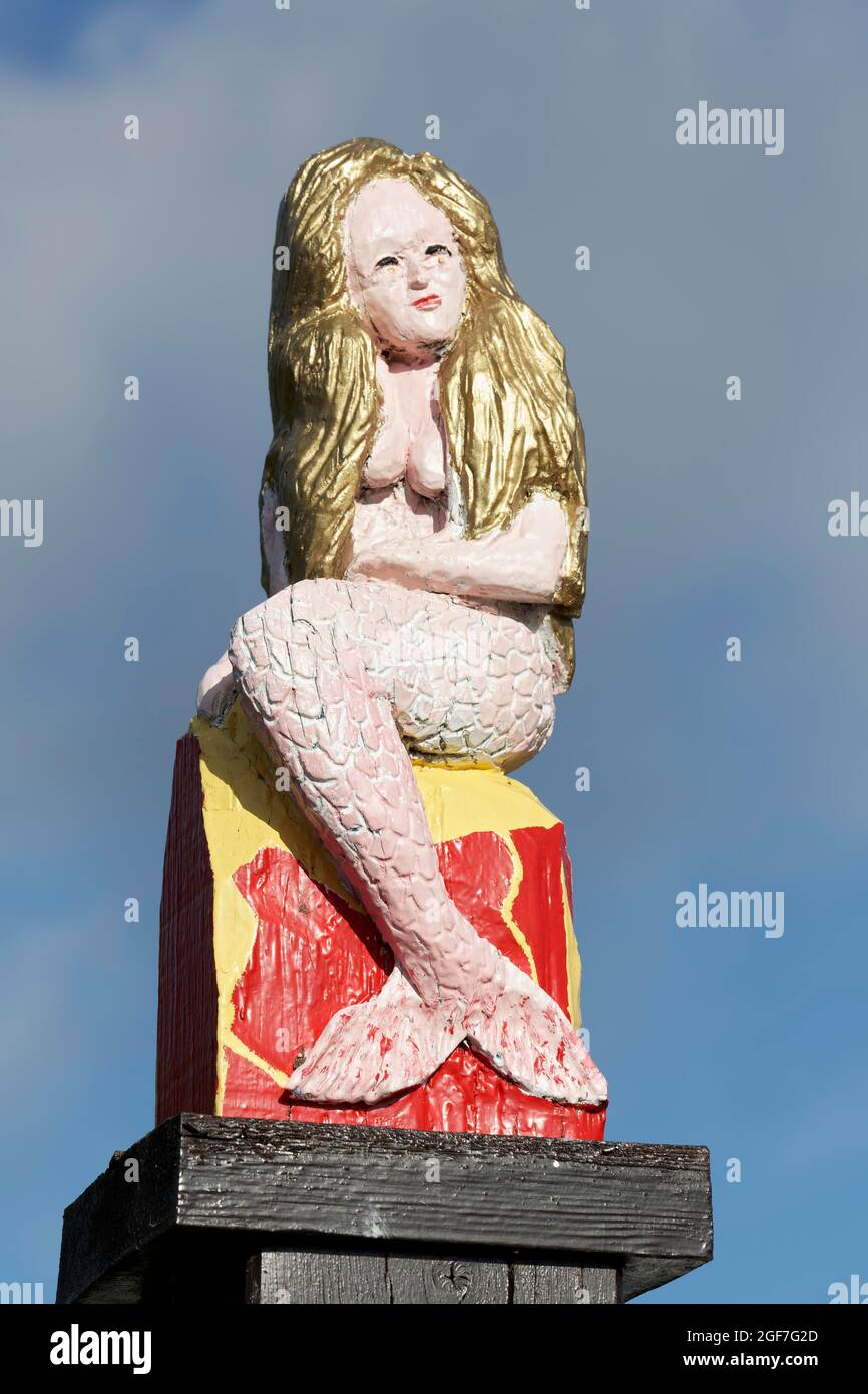 Mermaid, carved figure, colourfully painted, on a street sign, List on Sylt, North Frisian Islands, Schleswig-Holstein, Germany Stock Photo