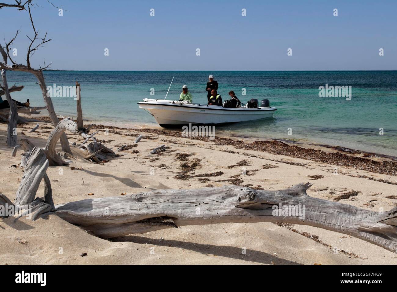 Boat with divers lands on the beach of Anclitas Islandi, Jardines de la Reina National Park, Archipelago, Camagueey and Ciego de Avila Province Stock Photo