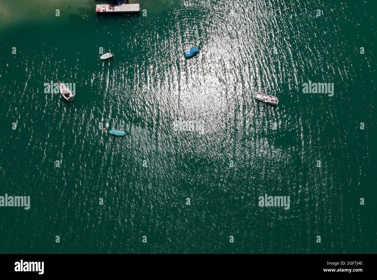Drone shot, boat from above at the lake in backlight with water reflection, Mondsee, Salzkammergut, Upper Austria, Austria Stock Photo