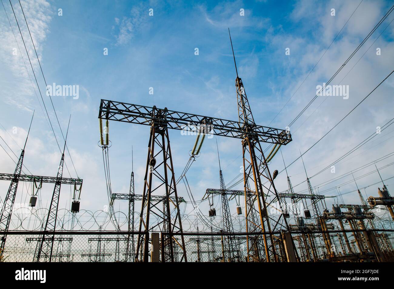 Electrical pylons and high voltage power lines are behind a barbed wire