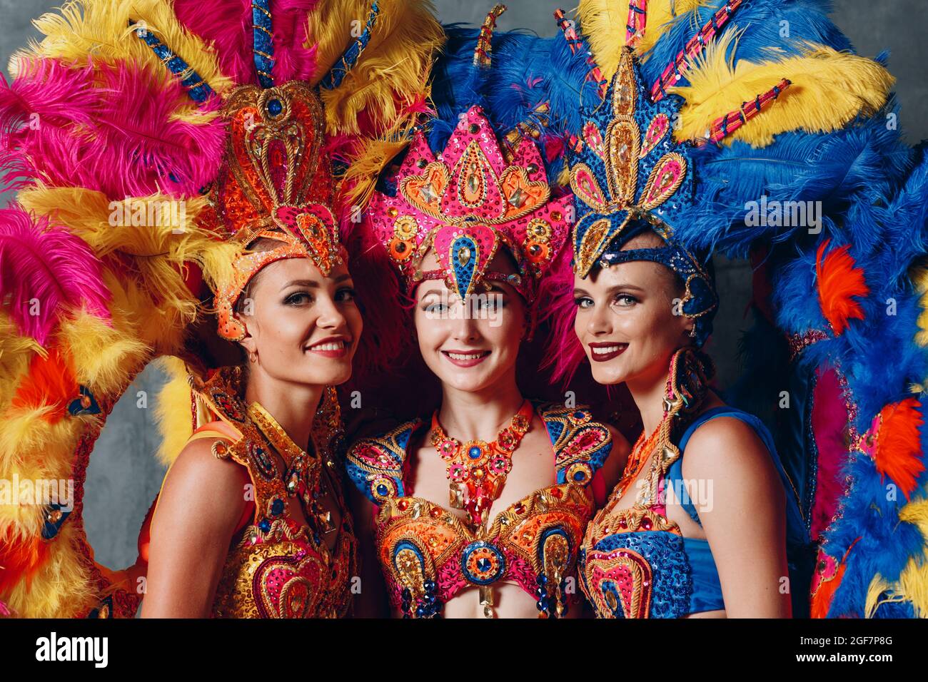 Three Woman in brazilian samba carnival costume with colorful feathers ...