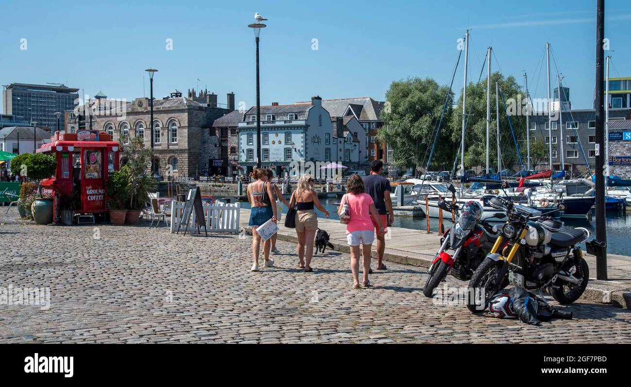 Plymouth, Devon, England, UK. 2021. Tourists walking on cobblestone roadway in the Barbican area on the Plymouth waterfront. Stock Photo