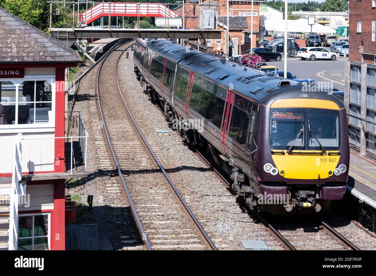 Train pulling out of Oakham station on a Monday afternoon, looking down